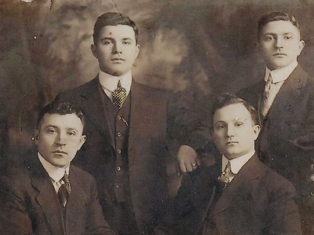 Andrew Sakell (Standing, Left) with his brothers George Sakell (standing right), Greg (seated left) and Tom Sakell (seated right).